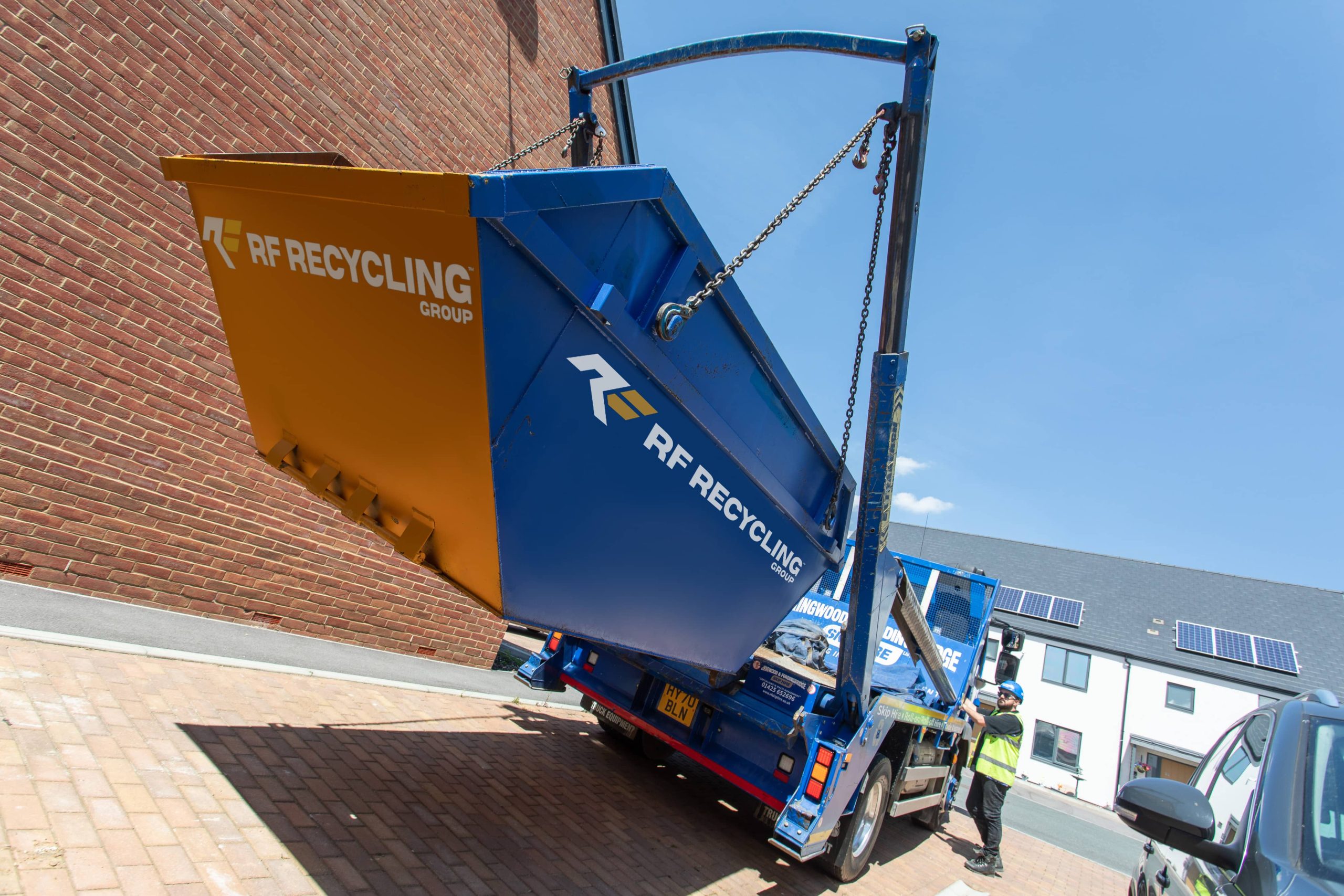 rf recycling skip being raised on to a truck